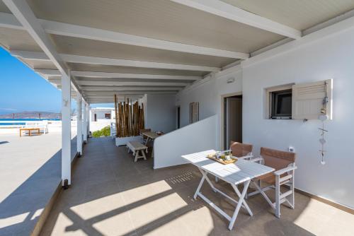 a dining room with a table and a view of the ocean at Anemi Suites in Adamas