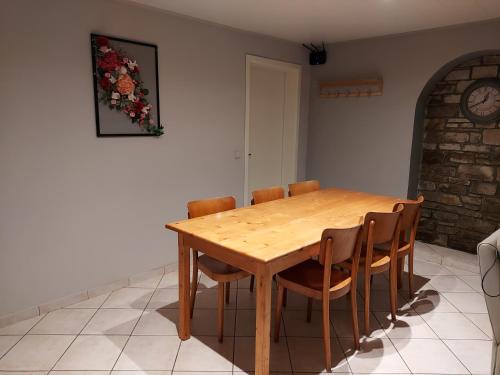 a wooden table and chairs in a room at A mon Châl in Waimes