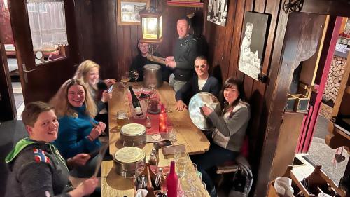 a group of people sitting around a table in a restaurant at Hocheckhuette On Top of the Kitzbuehel Hahnenkamm Mountain in Kitzbühel