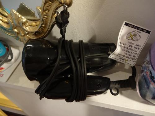 a black hair dryer sitting on a shelf at Nikko Park Lodge Mountain Side in Nikko