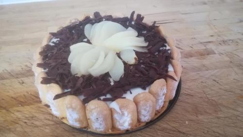 a cake with flowers on top of it on a table at La petite maison dans la prairie in Notre-Dame-du-Touchet