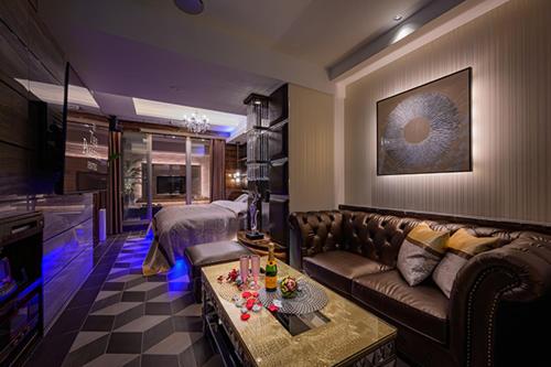 a living room with a couch and a table at HOTEL パサディナ11 Adult Only in Saitama