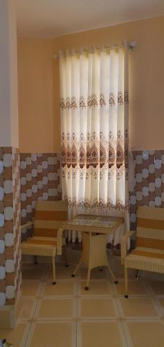 a room with two benches and a curtain at NHÀ NGHỈ VIỆT NGA in Ha Tien
