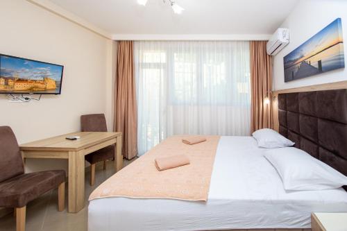 a hotel room with a bed and a desk at Apartment Sofija in Budva