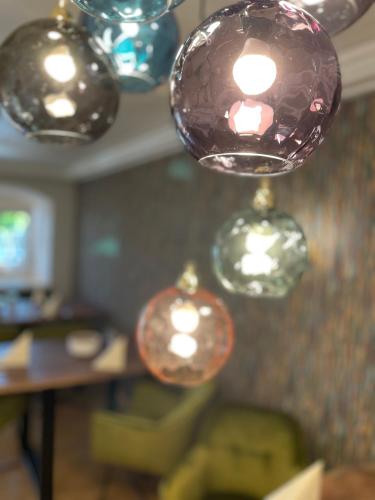 a bunch of glass balls hanging from a ceiling at Landhaus Kössel in Füssen
