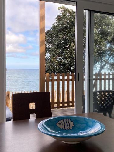 a plate on a table with a view of the ocean at Mariana Plage in La Marana