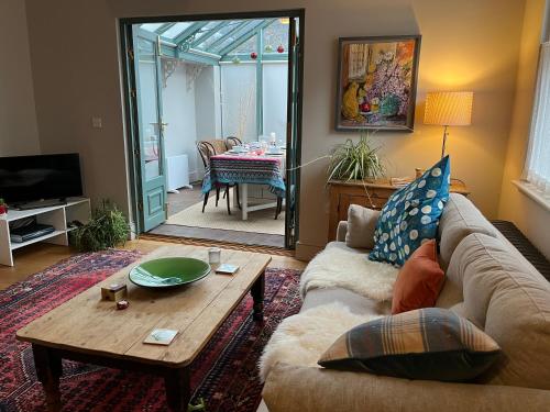 a living room with a couch and a table at Pretty Cottage in Central Lewes in Lewes