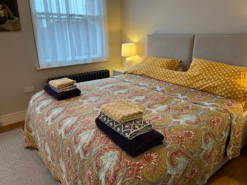 a bedroom with a bed with two pillows on it at Pretty Cottage in Central Lewes in Lewes