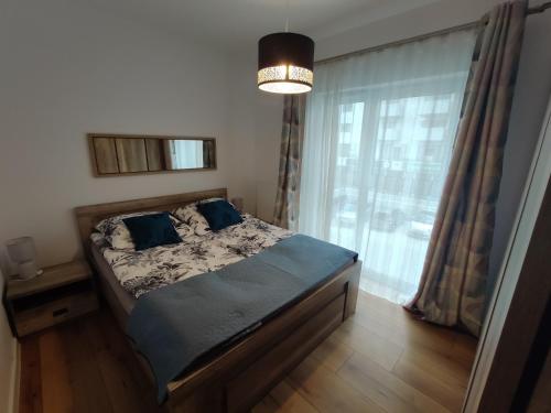 Vuode tai vuoteita majoituspaikassa Apartament Parkowy