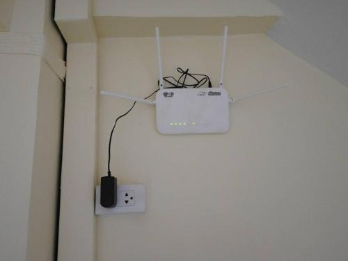a computer monitor hanging from a ceiling with a cord at C&TApartment in Ban Thai Don (1)
