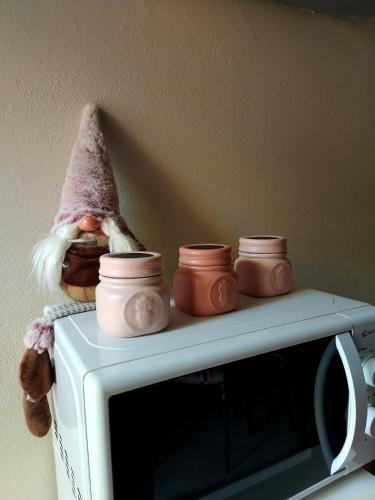 a pile of pots on top of a microwave at Cascina Roella in Monforte dʼAlba