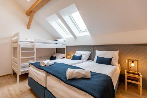 a bedroom with a bed and a bunk bed at Benátky 214 in Vranov nad Dyjí