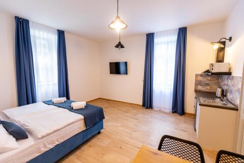 a bedroom with a bed and a table and chairs at Benátky 214 in Vranov nad Dyjí