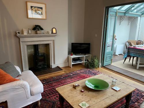 a living room with a couch and a table at Pretty Cottage in Central Lewes in Lewes