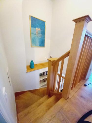a room with a staircase with a painting on the wall at Pretty Cottage in Central Lewes in Lewes