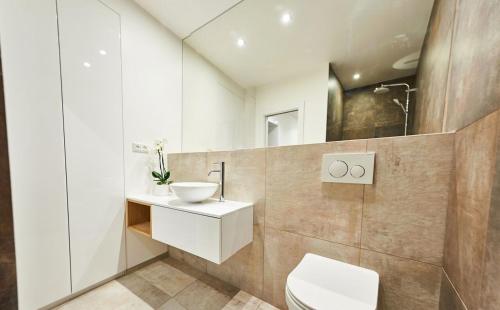 a bathroom with a sink and a toilet in it at Beautiful apartment near the city center in Košice