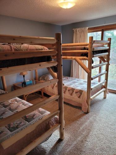 a room with three bunk beds and a window at Cable Townhome #3 condo in Cable