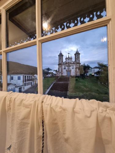 an open window with a view of a building at Teatro Hotel Boutique in Ouro Preto