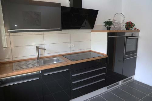 a kitchen with a sink and a microwave at Ferienwohnung Kassel in Kassel