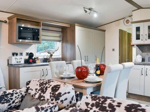 a kitchen with a table and chairs in a kitchen at 2 Bed Lodge - Sleeps 6 - Dogs - Hot Tub - Parking in Bridlington