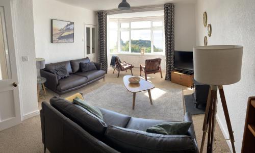 a living room with a couch and a table at Seaview Cottage in Aberdyfi