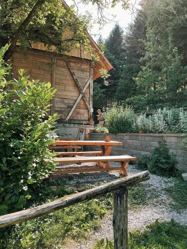 a wooden bench sitting in front of a building at Vintage tent at the Lovsin Estate in Metlika