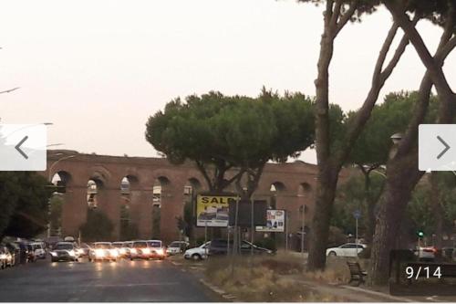 a street with cars parked in front of a building at A casa di Alice in Rome
