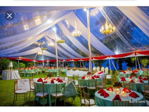 a large tent with tables and chairs in a field at Hakuna Matata Lodge in Gisenyi