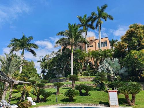 a resort with palm trees and a building at Hotel Santa Luisa Finca Boutique in Tecolutla