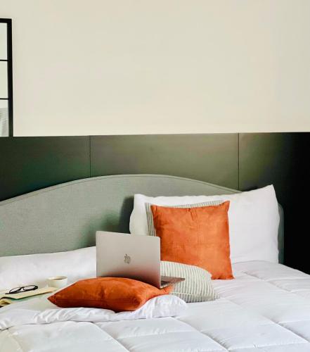 a bed with a laptop computer on top of it at Canaryislandshost l Balcón del Mar in Puerto del Carmen