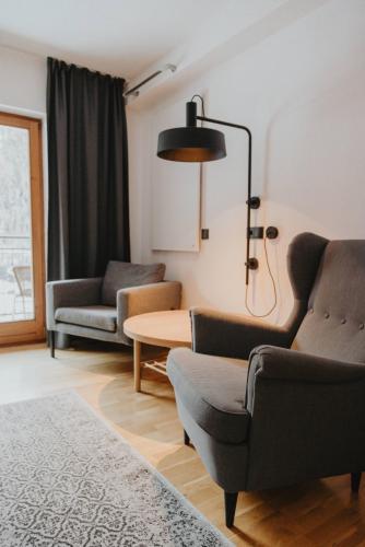 a living room with two chairs and a table at Gästehaus Kolp in Sankt Anton am Arlberg