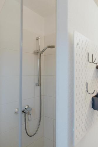 a shower with a glass door in a bathroom at Gästehaus Kolp in Sankt Anton am Arlberg