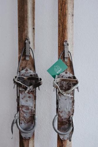 two lights hanging on a wall with a green sign at Gästehaus Kolp in Sankt Anton am Arlberg