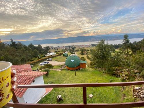 a view from a balcony with a green tent at Glamping sede campestre Mirador de Pueblo Viejo in Guatavita
