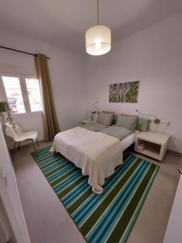 a bedroom with a bed and a rug at B&B Buena Vista in Alhaurín el Grande