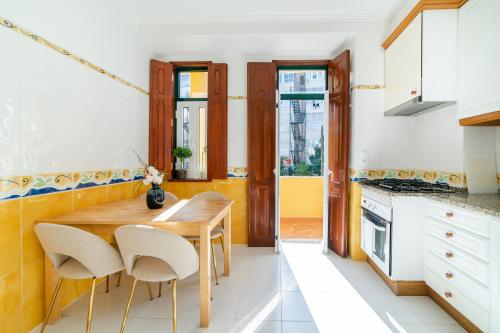 a kitchen with a wooden table and chairs at Your New Home in Lisbon - AC and Fast Wi-Fi in Lisbon