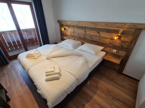 a bedroom with a bed with two towels on it at Hotel Pension Annerlhof in Maria Alm am Steinernen Meer