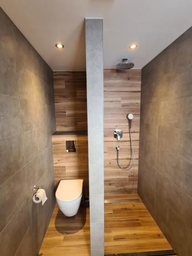 a bathroom with a toilet and a shower at Hotel Pension Annerlhof in Maria Alm am Steinernen Meer