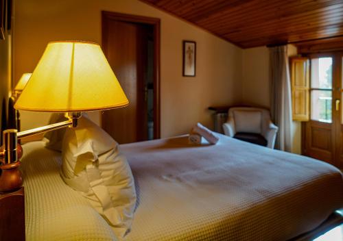 a bedroom with a bed with a lamp on it at Can Misse in Collbató