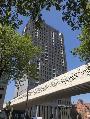 a tall building with a bridge in front of it at "VH apartment" - center of Antwerp - free parking in Antwerp