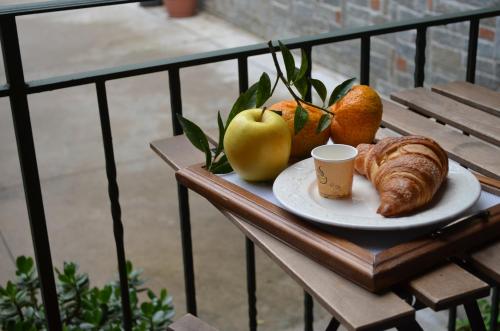 a plate of fruit and a cup of coffee on a table at Midway House Italy Apartment in Sant'Egidio del Monte Albino