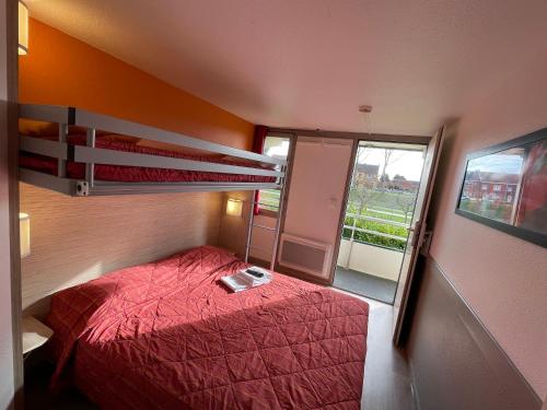 a bedroom with a bed and a bunk bed at Premiere Classe Dunkerque Saint Pol Sur Mer in Saint-Pol-sur-Mer