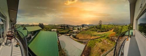 a view from the balcony of a house with a green roof at Moon Plains Luxury Apartments in Nuwara Eliya