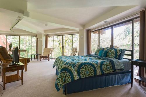 a bedroom with a bed and some windows at Bright, Unique Apartment in Heart of Wine Country in Newberg