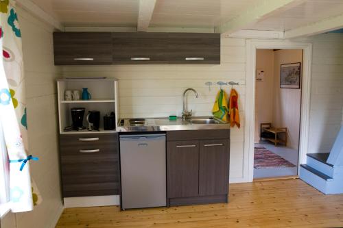 a kitchen with a sink and a counter top at Cozy cabin with stunning view in Alstad