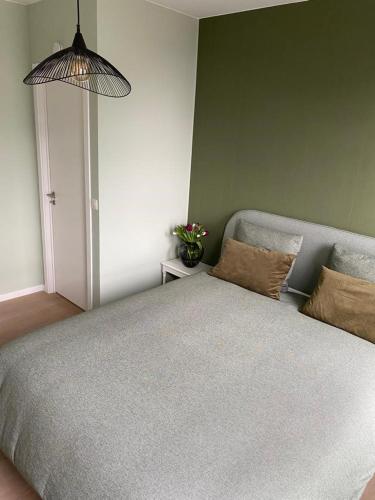 a bedroom with a bed and a potted plant at "VH apartment" - center of Antwerp - free parking in Antwerp