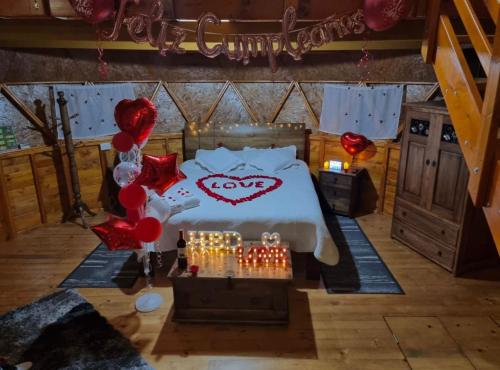a bedroom with a bed with a love sign on it at Glamping sede campestre Mirador de Pueblo Viejo in Guatavita