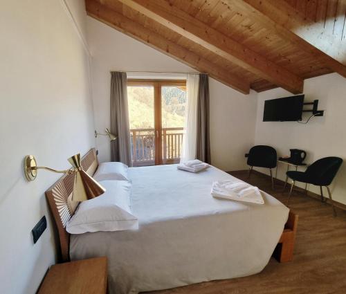 ein Schlafzimmer mit einem großen Bett und einem Fenster in der Unterkunft Agriturismo Donec in Villa dʼAllegno