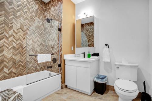 a bathroom with a toilet and a sink and a shower at NEW! Vibrant Large Studio Dwntwn 18 Mins to NYC in Newark