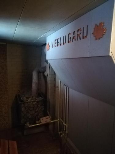 a sign for a restroom in a building at Oāze Smiltenē in Smiltene